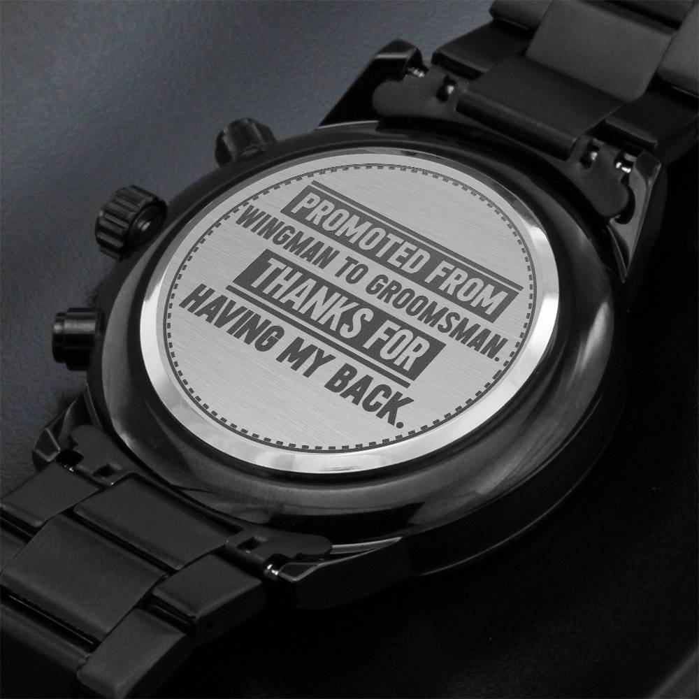 Black metal watch back engraved with Promoted From Wingman to Groomsman. Thanks for having my back.